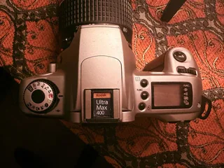My thrifted pick for a film camera: Canon EOS 300 with a quite simple and bulky zoom lens EF 28–80mm f/3.5–5.6 II. This one is exactly from the transition to the digital period, so it has a lot of digital features, autofocus, and metering. Simple to use for a film beginner like me.