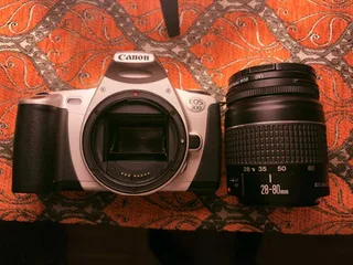 My thrifted pick for a film camera: Canon EOS 300 with a quite simple and bulky zoom lens EF 28–80mm f/3.5–5.6 II. This one is exactly from the transition to the digital period, so it has a lot of digital features, autofocus, and metering. Simple to use for a film beginner like me.