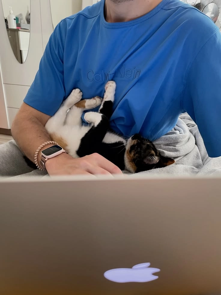 Photo of me with the cat named Kartoshka sleeping in my hands
