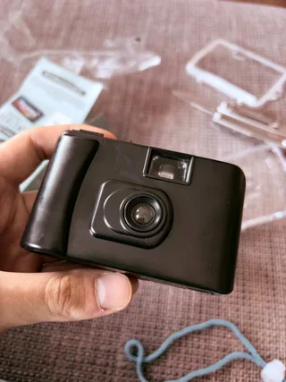 You can remove waterproof housing and see a small black camera inside that can only shoot and advance film. On the bottom there is a rewinding mechanism, technically you can remove and replace the film and use it again. But it only supports 400 ISO.