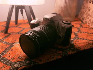 My thrifted pick for a film camera: Canon EOS 300 with a quite simple and bulky zoom lens EF 28–80mm f/3.5–5.6 II. This one is exactly from the transition to the digital period, so it has a lot of digital features, autofocus, and metering. Simple to use for a film beginner like me.