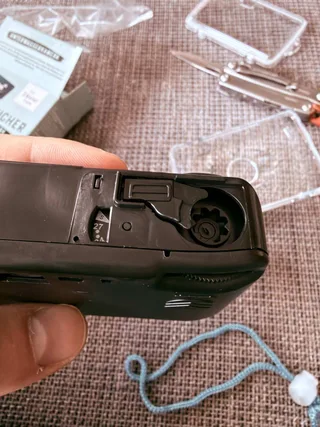 You can remove waterproof housing and see a small black camera inside that can only shoot and advance film. On the bottom there is a rewinding mechanism, technically you can remove and replace the film and use it again. But it only supports 400 ISO.