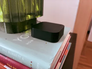 Photo of black IR blaster on top of books.